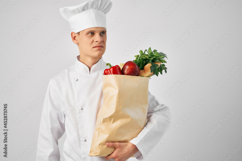 Chef with a package of groceries kitchen cooking food work Chef with a package of groceries kitchen cooking food work