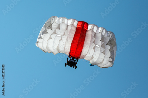 Parachute in the sky. Skydiver is flying a parachute in the blue sky. photo