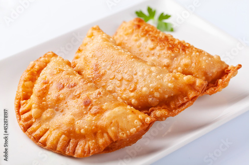 Close up of tuna patty, empanadillas, on white background photo