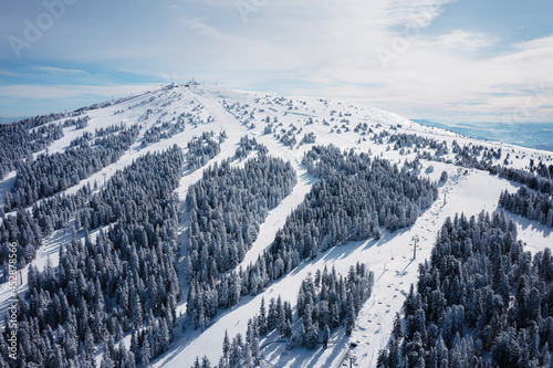 Panorama of the ski resort Kopaonik in Serbia. Kopaonik National Park, winter landscape in the mountains, coniferous forest covered with snow photo