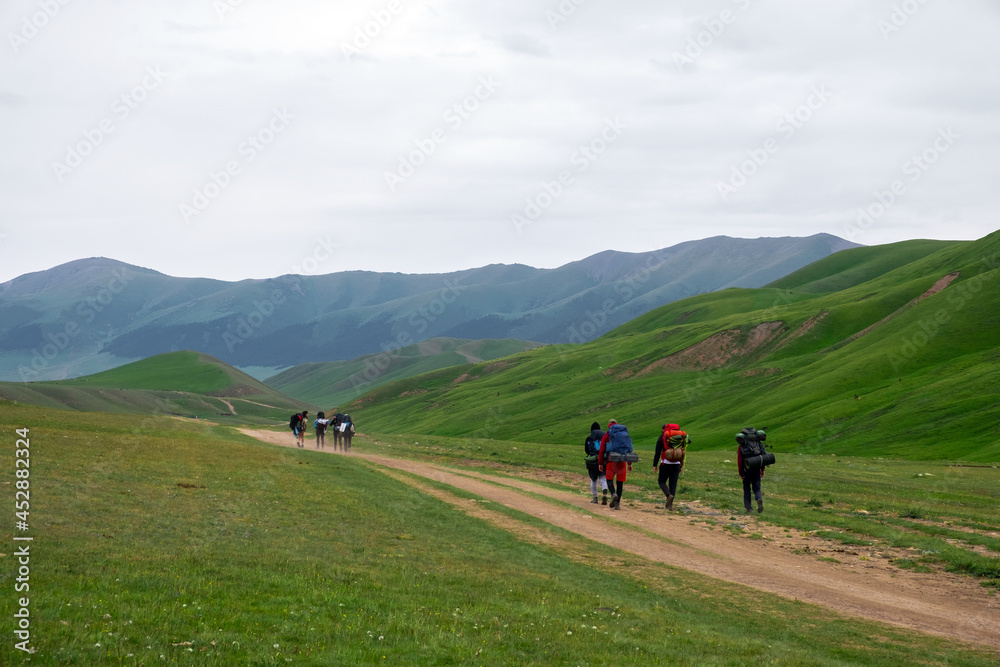 A group of backpackers are walking on mountain plateau. Travel, tourism concept. Nature landscape. Freedom journey.