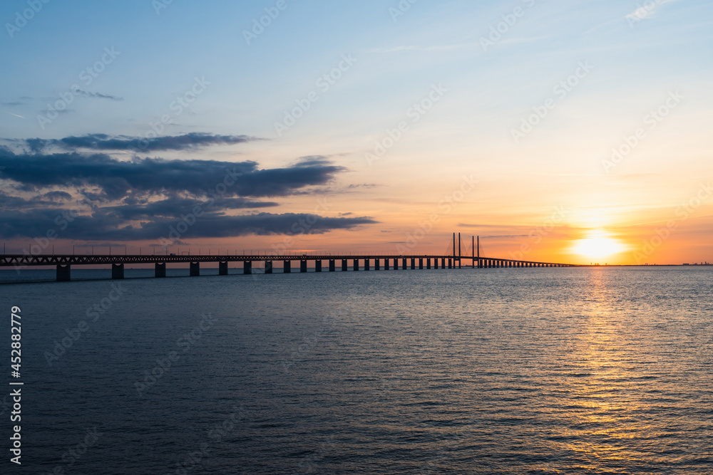 The Oresund Bridge is a combined motorway and railway bridge between Sweden and Denmark (Malmo and Copenhagen). Captured during golden sunset.