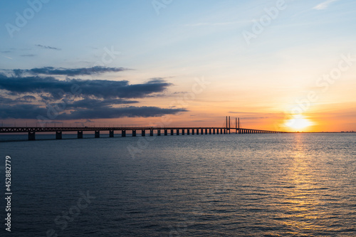 The Oresund Bridge is a combined motorway and railway bridge between Sweden and Denmark  Malmo and Copenhagen . Captured during golden sunset.