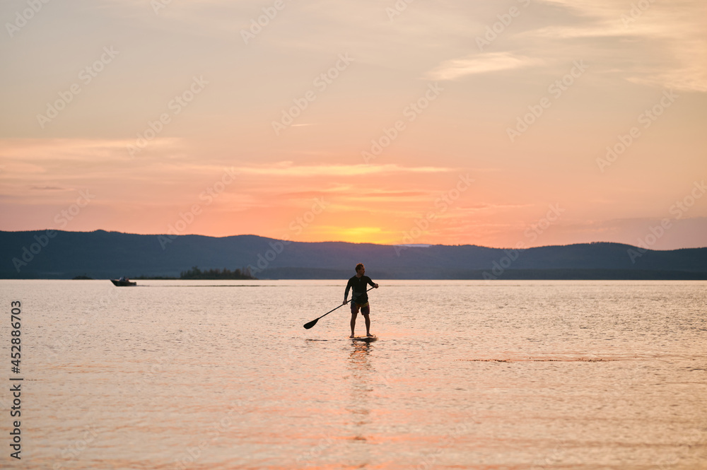Man paddling the board with scenic view