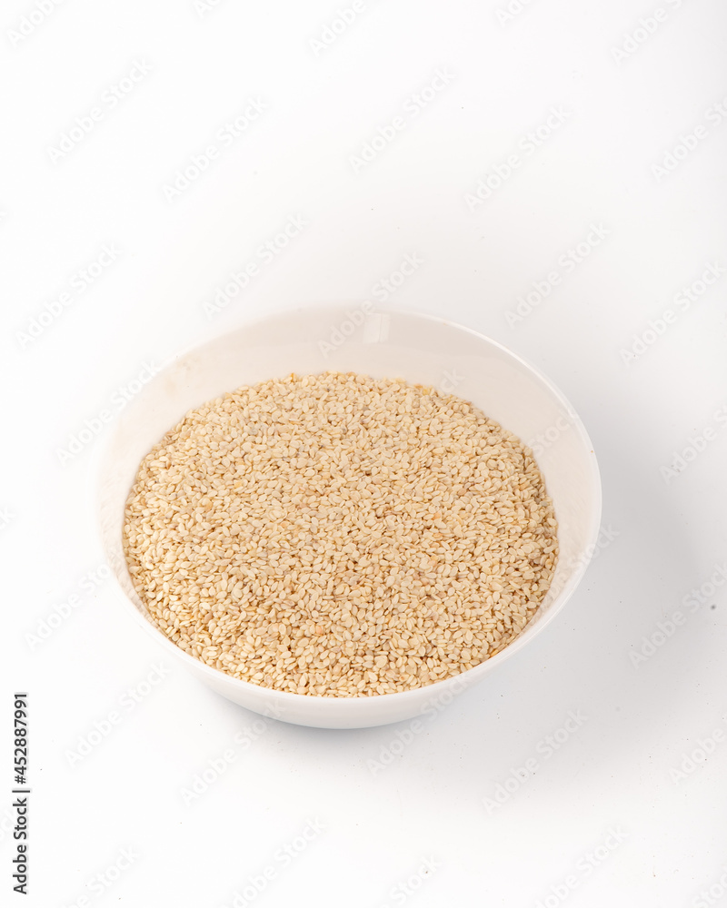 White sesame seeds in a white plate isolated on a white background. High quality photo White sesame seeds in a white plate isolated on a white background. High quality photo