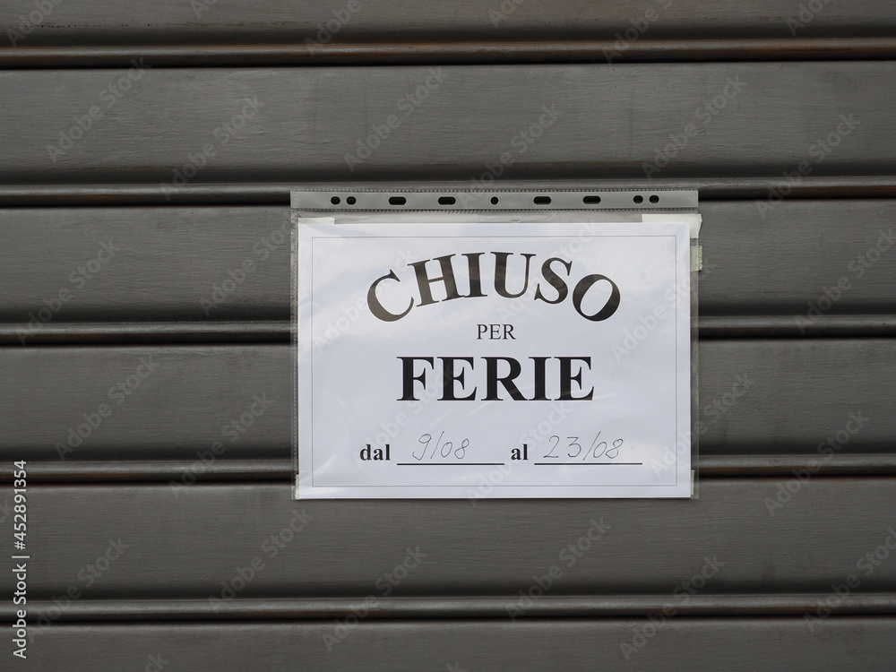 chiuso per ferie (translation: closed for holidays) sign chiuso per ferie (translation: closed for holidays) sign