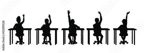 Children raising hands in classroom silhouette