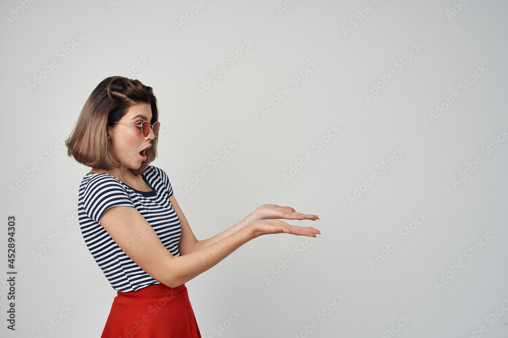 pretty woman in red skirt in striped t-shirt elegant stylish light background pretty woman in red skirt in striped t-shirt elegant stylish light background
