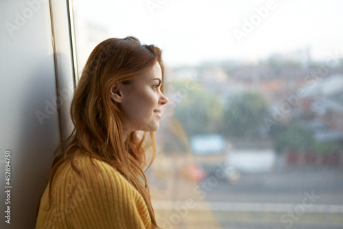 beautiful woman in a yellow sweater at home