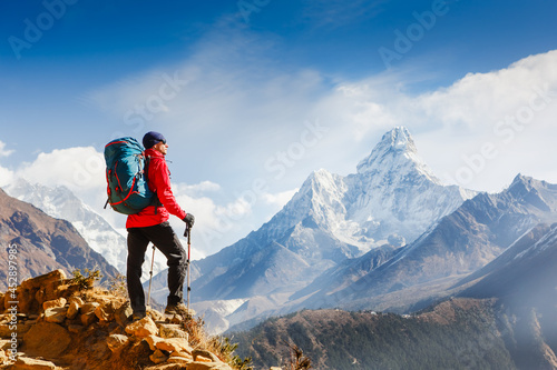 Hiker enjoying the view on the Everest trek in Himalayas, Ama Dablam mountain view, Nepal