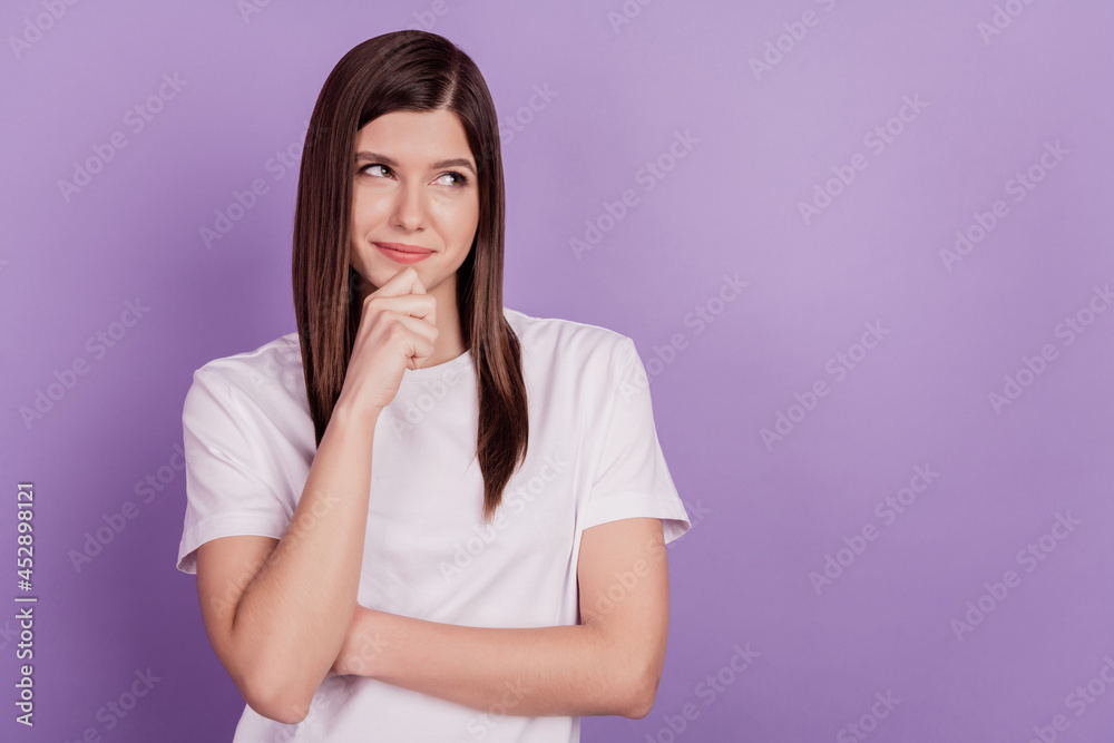 Photo of tricky lady looking empty space think finger chin isolated purple background Photo of tricky lady looking empty space think finger chin isolated purple background