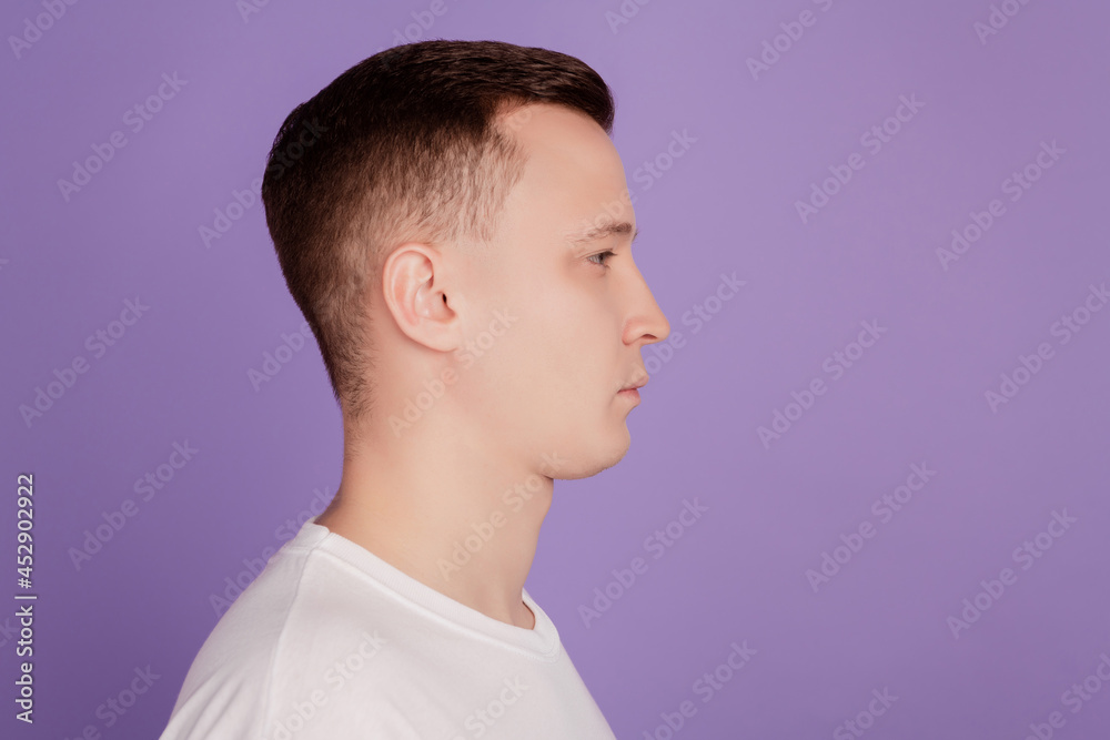 Fototapeta premium Profile portrait of calm focused serious guy look empty space on violet background