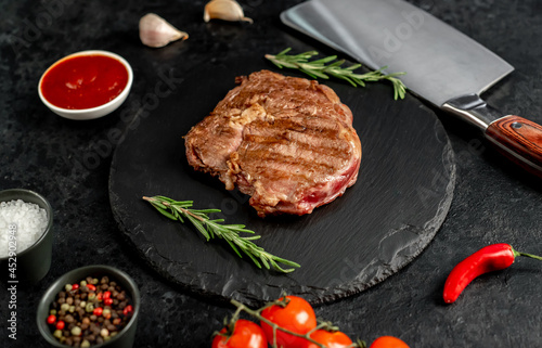 Ribeye grilled steak on stone background 