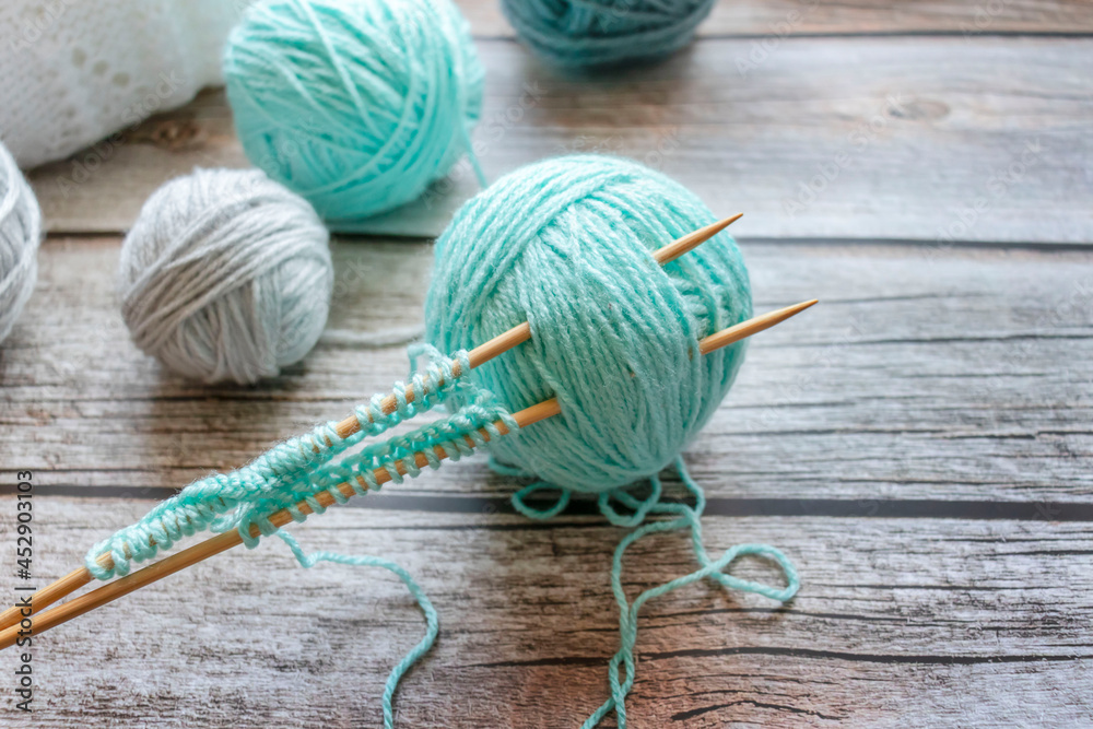 Knitting with needles. Against the background of a tree. handmade