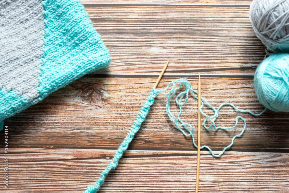 Knitting with needles. Against the background of a tree. handmade Knitting with needles. Against the background of a tree. handmade