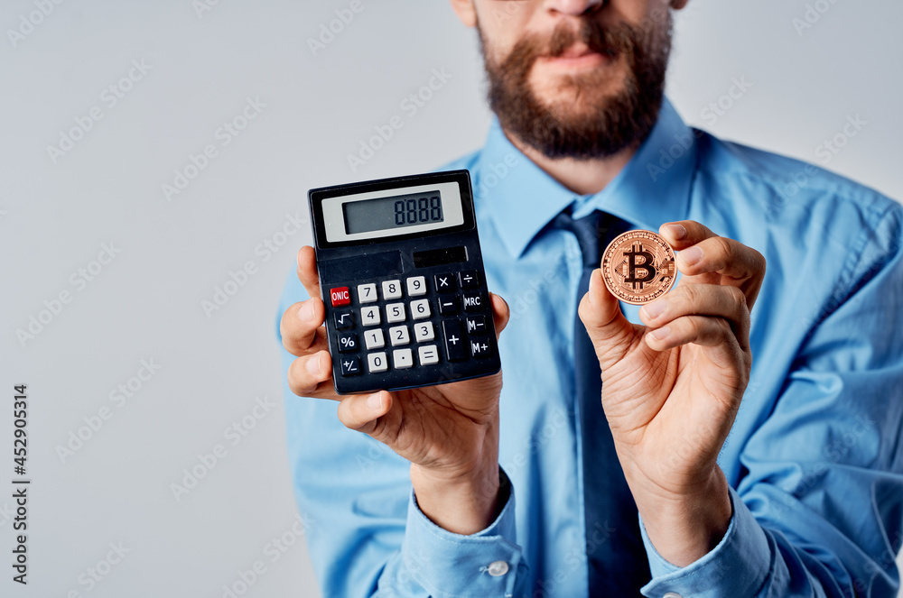 man holding a calculator cryptocurrency bitcoin virtual money investment man holding a calculator cryptocurrency bitcoin virtual money investment