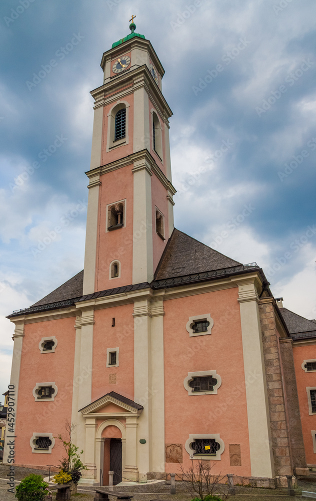 The parish church of St. Andreas in Berchtesgaden in Bavaria, Germany under a cloudy sky in spring. It was erected in 1397 by the citizens of the market town of Berchtesgaden.