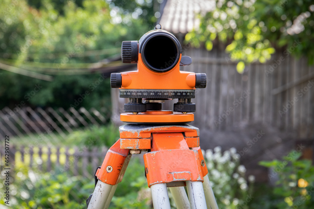 Automatic Level. Work tool. Outside, sunny day Automatic Level. Work tool. Outside, sunny day