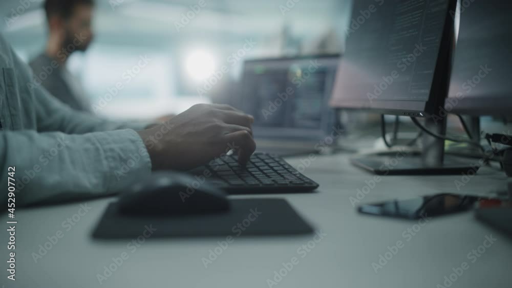 Office: Black IT Programmer Using Keyboard Typing, Using Mouse while Working on Desktop Computer. Specialist Creating Software. Engineer Developing App, Program, Video Game. Focus on Hands