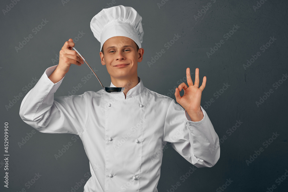male chef with a ladle in his hands is trying dishes restaurant professional male chef with a ladle in his hands is trying dishes restaurant professional