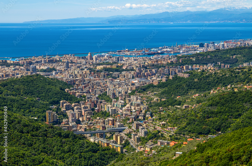 Aerial view of the city of Genoa and its port in a sunny day, Italy.