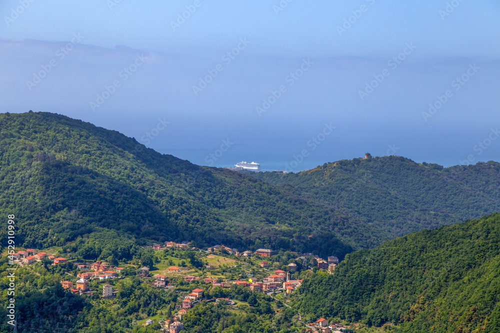 A large cruise ship emerges from the heights of Genoa, Italy.