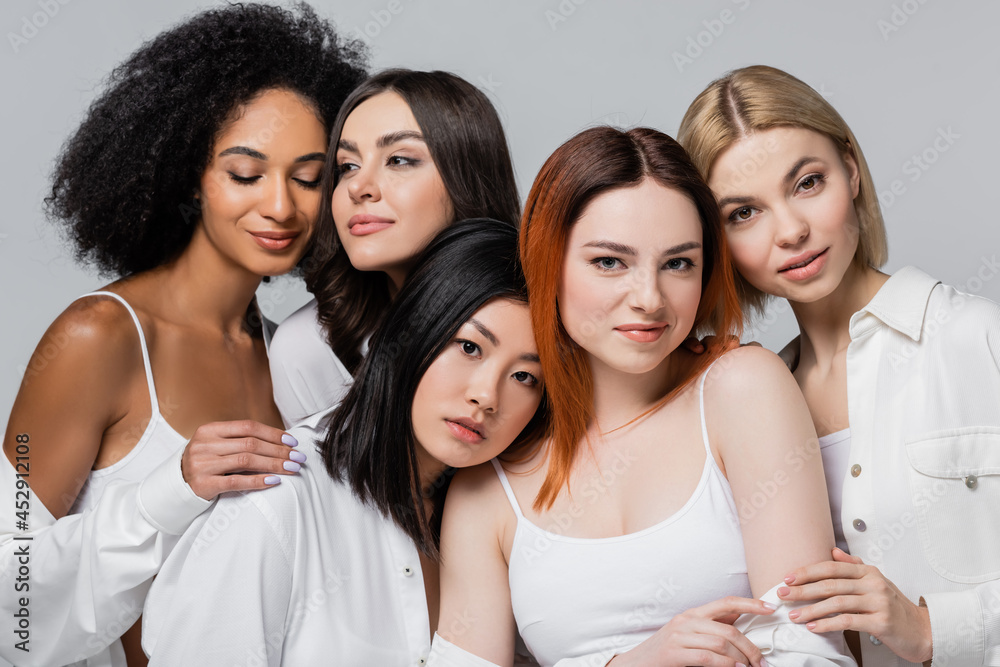 asian and african american models posing with young women isolated on grey