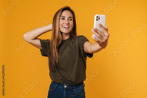 Happy mid aged casual woman taking selfie
