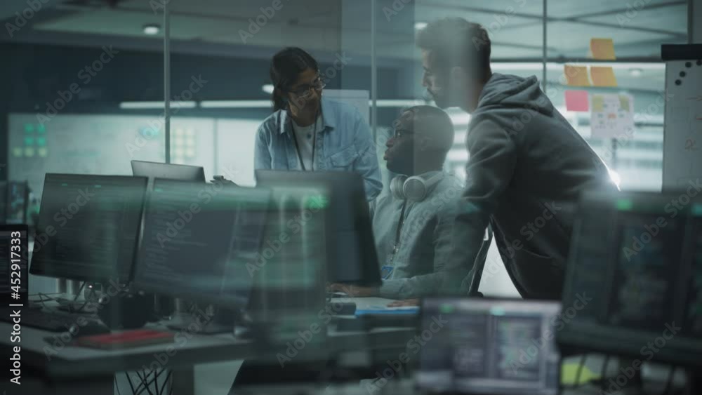 Diverse Group of Professionals Meeting in Modern Office: IT Programmers Use Computer, Talk Strategy, Discuss Planning. Specialists Create Innovative Software. Engineers Develop Inspirational App