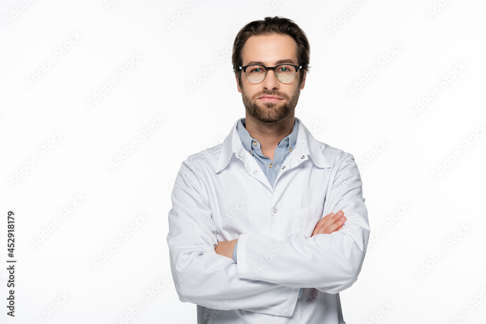 Serious doctor standing with crossed arms isolated on white Serious doctor standing with crossed arms isolated on white
