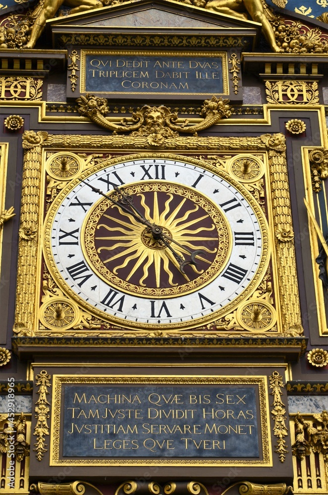 Gilded Conciergerie clock hang on the Clock Tower of the Conciergerie in Paris