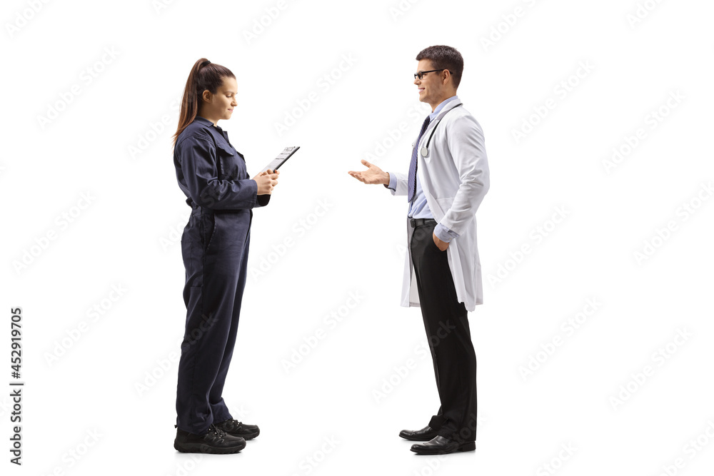Full length profile shot of a male doctor talking to a female auto mechanic worker Full length profile shot of a male doctor talking to a female auto mechanic worker