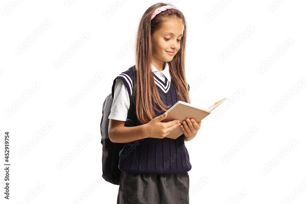 Happy schoolgirl in a uniform reading a book Happy schoolgirl in a uniform reading a book