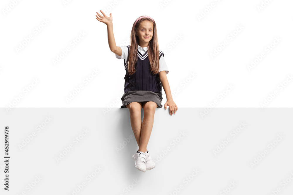Schoolgirl with long hair sitting on a blank panel and waving Schoolgirl with long hair sitting on a blank panel and waving