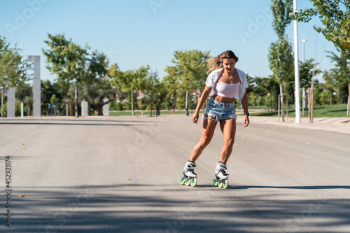 Woman in rollerblades and showing stunt photo