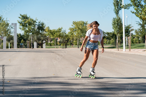 Woman in rollerblades and showing stunt