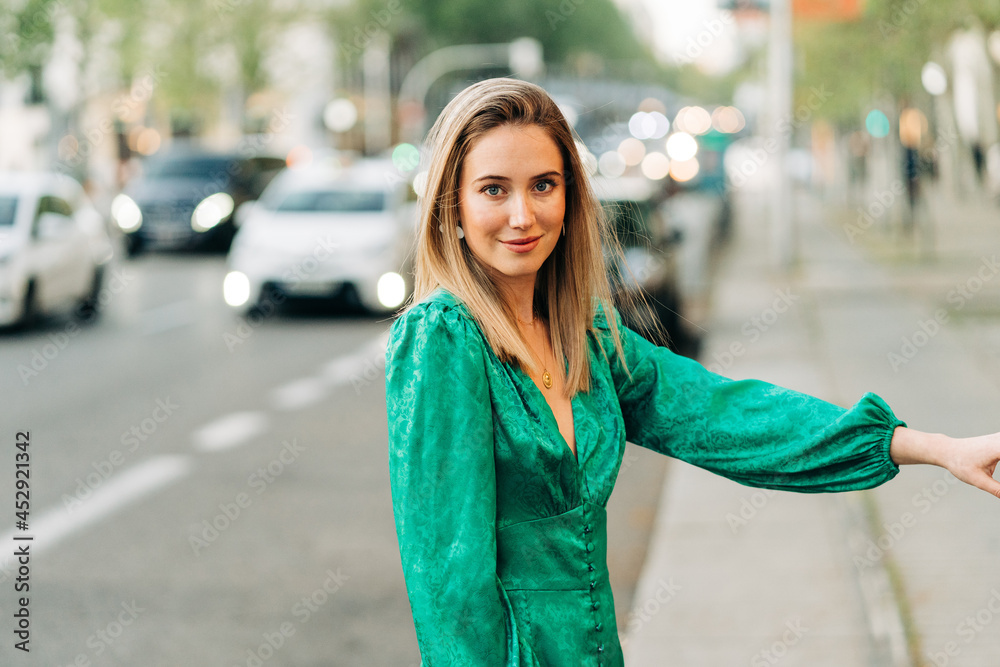 Happy woman in stylish green dress in city Happy woman in stylish green dress in city