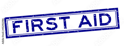Grunge blue first aid word square rubber seal stamp on white background