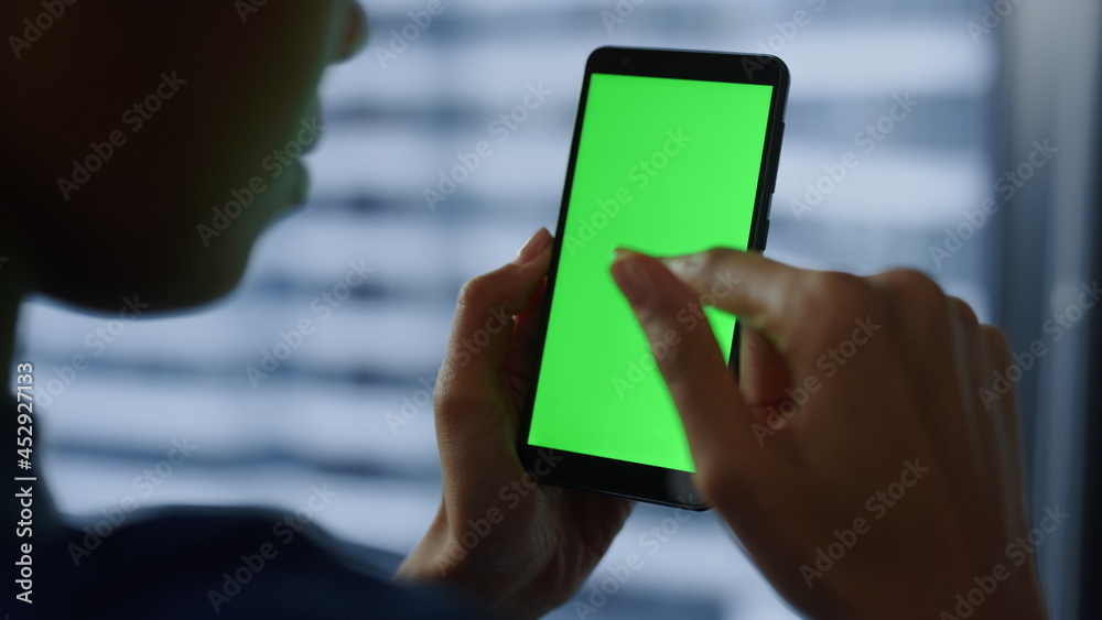 Businesswoman using mobile phone with green screen. Woman chatting on cellphone 