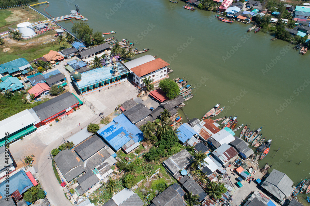 Aerial view top down view of a group of fishing vessels or boats in a fishing village Drone view above the fishing village.