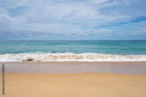 Summer sandy beach Amazing sea clear blue sky and white clouds Wave crashing on sandy shore empty beach at Phuket Thailand, Empty beach Concept Travel and season tour website background.