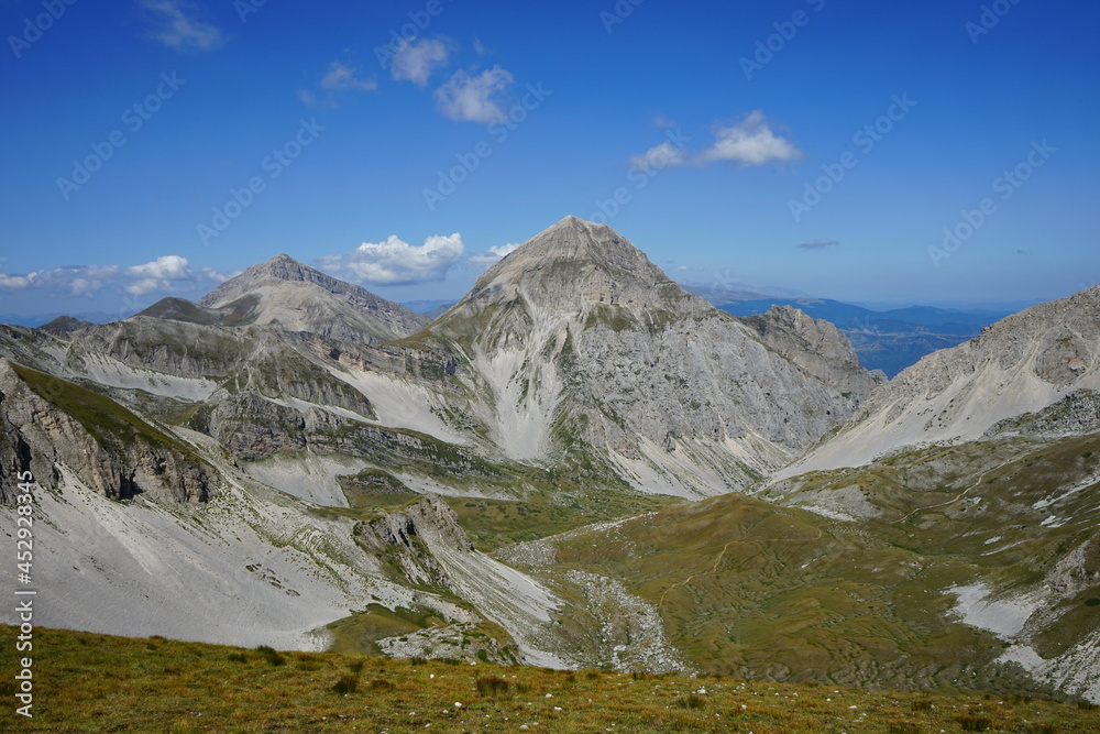Gran Sasso National park valley view from the top of the mountain on a summer trekking day, Campo Imperatore, Abruzzo, Italy