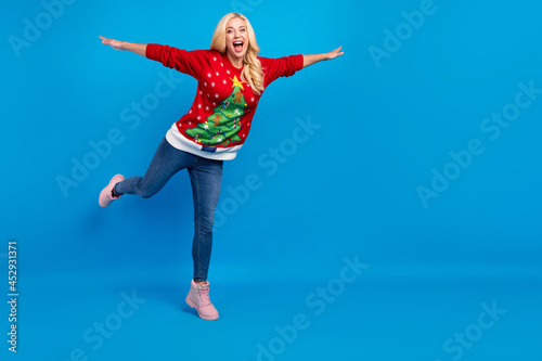 Full length photo of young happy woman hands wings fly good mood smile isolated on blue color background