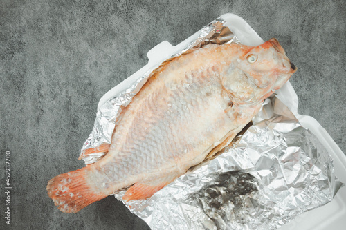 Grilled Tubtim fish placed on foil paper