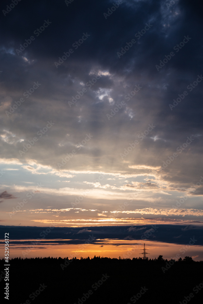 God rays on the forest. The sun's rays shine through the clouds. The power of the sky and a riot of colors. Copy space.