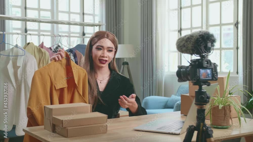 Young Asian Shemale Selling Clothes Online By Live Streaming. Selling It Online Live Streaming Concept Видео Stock | Adobe Stock
