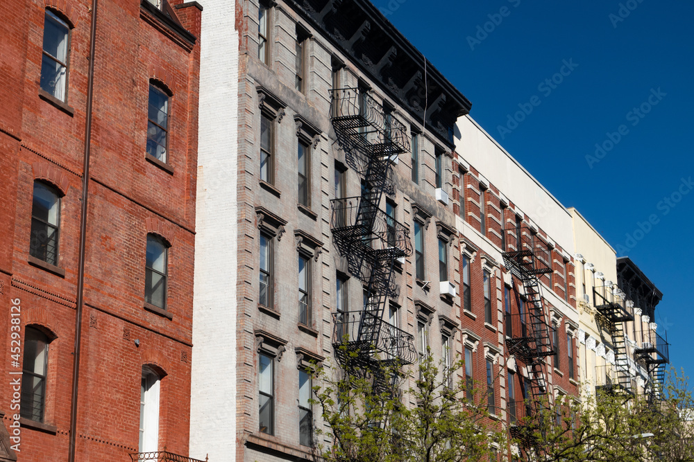 Row of Colorful Old Brick Apartment Buildings with Fire Escapes in the East Village of New York City