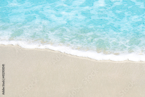 Close up Soft beautiful ocean wave on sandy beach for background