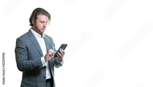 Business man or traveler wearing suit using mobile phone on white background with space for text or copy