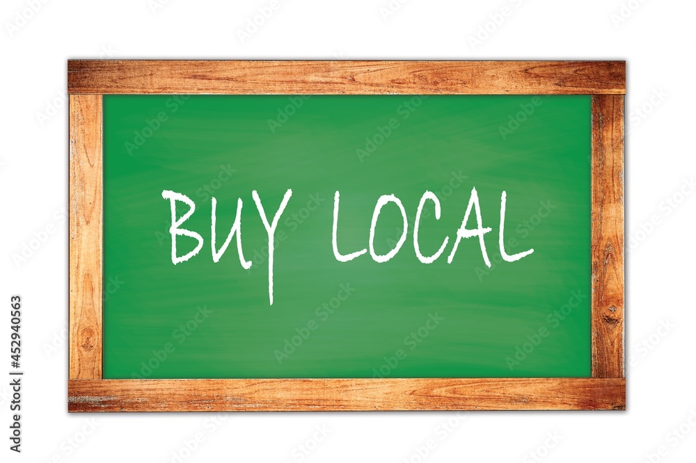 BUY LOCAL text written on green school board. BUY LOCAL text written on green school board.
